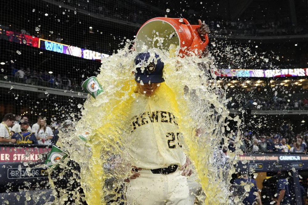 Milwaukee Brewers' Andrew Vaughn (28) gets splashed by Andruw Monasterio after a baseball game against the Chicago Cubs, Tuesday, July 29, 2025, in Milwaukee. (AP Photo/Aaron Gash)