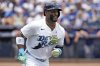 Tampa Bay Rays' Yandy Díaz watches his solo home run off Los Angeles Dodgers pitcher Blake Snell during the first inning of a baseball game Saturday, Aug. 2, 2025, in Tampa, Fla. (AP Photo/Chris O'Meara)