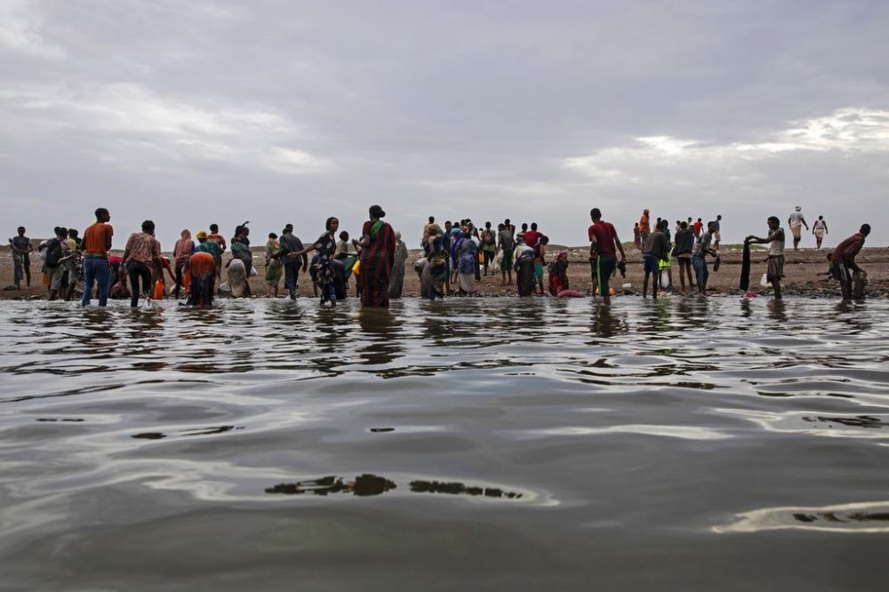 FILE - Ethiopian migrants walk on the shores of Ras al-Ara, Lahj, Yemen, after disembarking from a boat, July 26, 2019. (AP Photo/Nariman El-Mofty, File)