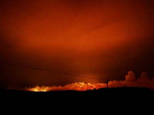 An out-of-control wildfire is shown in this handout photo near Musgrave Harbour, N.L., just before midnight on July 20, 2025. THE CANADIAN PRESS/Handout — Kyle Gaulton (Mandatory Credit)