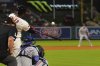 Los Angeles Angels' Jorge Soler, center, hits a two-run home run as Texas Rangers catcher Kyle Higashioka watches during the eighth inning of a baseball game Wednesday, July 9, 2025 in Anaheim, Calif. (AP Photo/Mark J. Terrill)