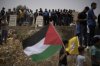 Mourners attend the funeral of the Palestinian teenager Amjad Nassar Awad Hawshiya, 15, who was killed in an Israeli raid, in the West Bank village of Yatta, south of Hebron, Tuesday, July 1, 2025. (AP Photo/Leo Correa)