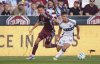 Vancouver Whitecaps midfielder Sebastian Berhalter, right, collects the ball with Colorado Rapids midfielder Cole Bassett in pursuit in the first half of an MLS soccer match Saturday, July 12, 2025, in Commerce City, Colo. (AP Photo/David Zalubowski)