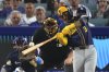 Milwaukee Brewers' Joey Ortiz, right, hits a solo home run as Los Angeles Dodgers catcher Will Smith watches during the eighth inning of a baseball game Saturday, July 19, 2025, in Los Angeles. (AP Photo/Mark J. Terrill)