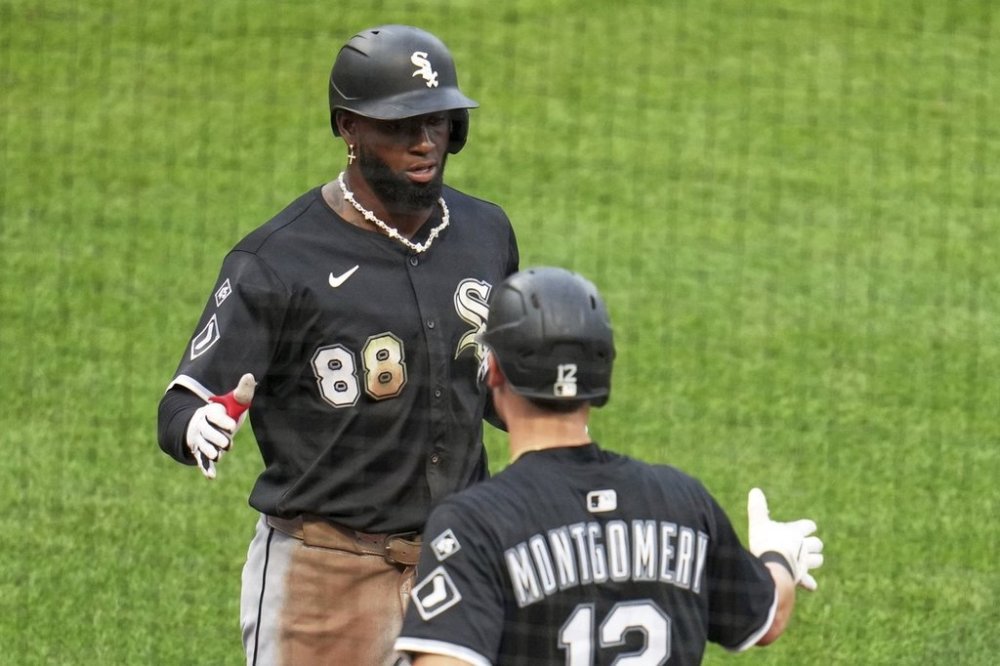 Chicago White Sox's Luis Robert Jr. (88) is greeted by Colson Montgomery as he returns to the dugout after hitting a solo home run off Pittsburgh Pirates pitcher Bailey Falter during the fourth inning of a baseball game in Pittsburgh, Friday, July 18, 2025. (AP Photo/Gene J. Puskar)