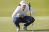Lottie Woad, of England, looks over her line during the first round of the women's Scottish Open golf tournament, Thursday, July 24, 2025, at Dundonald Links in Irvine, Scotland. (Steve Welsh/PA via AP)