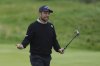 Xander Schauffele of the United States reacts after putting on the 13th green during a practice round for the British Open golf championship at the Royal Portrush Golf Club, Northern Ireland, Tuesday, July 15, 2025. (AP Photo/Jon Super)