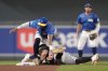 Pittsburgh Pirates' Tommy Pham, bottomleft, is tagged out by Minnesota Twins shortstop Carlos Correa, top left, during the seventh inning of a baseball game Friday, July 11, 2025, in Minneapolis. Correa was injured on the play. (AP Photo/Abbie Parr)