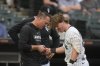Chicago White Sox's Chase Meidroth (10) is examined after he was hit in the hand with a pitch from Philadelphia Phillies starting pitcher Taijuan Walker (99) during the fifth inning of a baseball game Wednesday, July 30, 2025, in Chicago. (AP Photo/Erin Hooley)