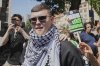 Liam Óg Ó hAnnaidh, aka Mo Chara, a member of the Irish language band Kneecap, leaves Westminster Magistrates Court London, Wednesday, June 18, 2025, where he is charged with a terrorism offence relating to displaying a flag in support of Hezbollah during a performance with the band in November 2024. (AP Photo/Kin Cheung)