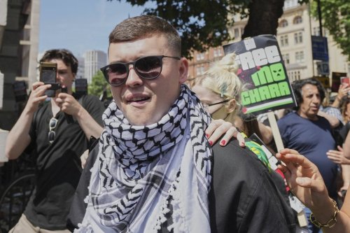 Liam Óg Ó hAnnaidh, aka Mo Chara, a member of the Irish language band Kneecap, leaves Westminster Magistrates Court London, Wednesday, June 18, 2025, where he is charged with a terrorism offence relating to displaying a flag in support of Hezbollah during a performance with the band in November 2024. (AP Photo/Kin Cheung)