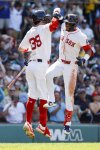 Boston Red Sox's Ceddanne Rafaela celebrates with Marcelo Mayer (39) after hitting a two run homer in the sixth inning of a baseball game, Sunday, July 13, 2025, in Boston. (AP Photo/Greg M. Cooper)