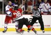 New York Rangers forward Nick Tarnasky (43) and Chicago Blackhawks centre Cody Bass (36) fight as linesman Andy McElman looks on during the first period of a preseason NHL hockey game on Friday, Sept. 26, 2014, in Chicago. (AP Photo/Andrew A. Nelles)