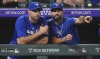 Toronto Blue Jays pitcher Max Scherzer, left,talks with assistant hitting coach Hunter Mense as they look on in the ninth inning of a baseball game against the Colorado Rockies, Monday, Aug. 4, 2025, in Denver. (AP Photo/David Zalubowski)