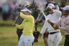 Miyu Yamashita, left, of Japan celebrates after winning the Women's British Open golf championship, at Royal Porthcawl Golf Club in Porthcawl, Wales, Sunday, Aug. 3, 2025. (AP Photo/Kin Cheung)