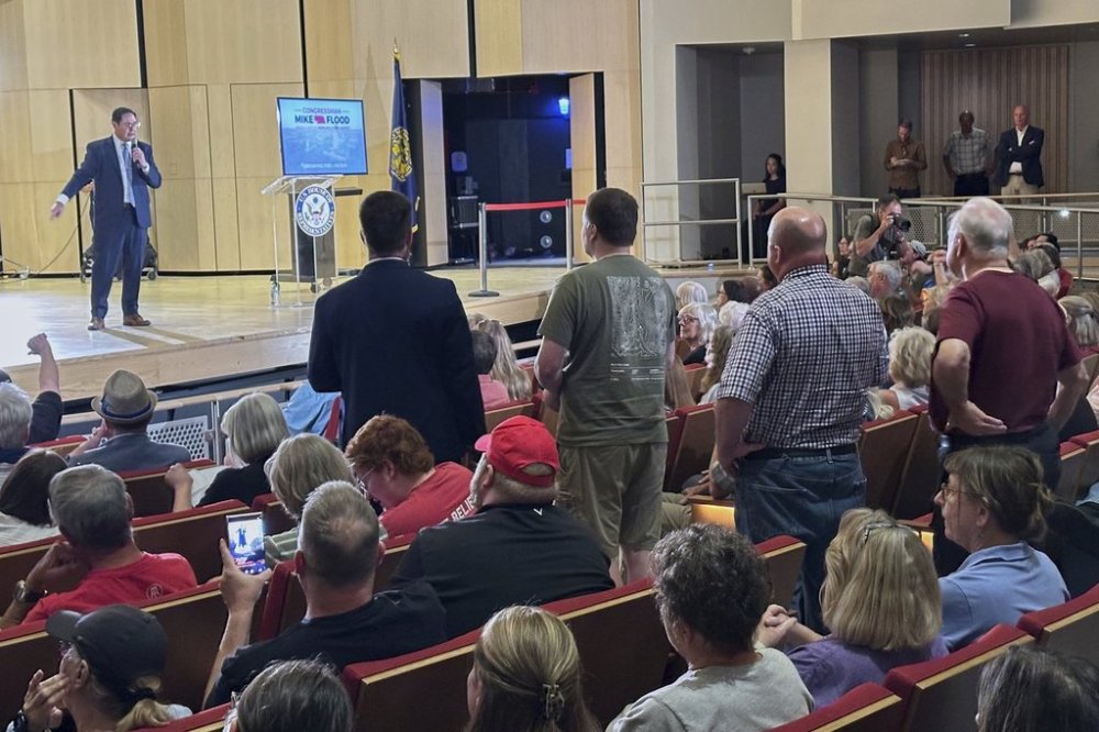 Rep. Mike Flood speaks and takes questions during a town hall meeting on the University of Nebraska campus, Monday, August 5, 2025 in Lincoln, Neb. The second-term Republican braved a Democratic-heavy audience of roughly 700, most of whom booed and chanted in opposition to the GOP-backed tax-break and spending-cut bill President Donald Trump signed last month. (AP Photo/Thomas Beaumont)