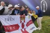 Rory McIlroy of Northern Ireland signs autographs on the 18th green following a practice round for the 2025 British Open golf championship at the Royal Portrush Golf Club, Northern Ireland, Monday, July 14, 2025. (AP Photo/Peter Morrison)