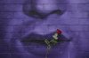 A flower is placed by a music fan to commemorate the death of Ozzy Osbourne in Birmingham, England, Wednesday, July 23, 2025. (AP Photo/Kin Cheung)
