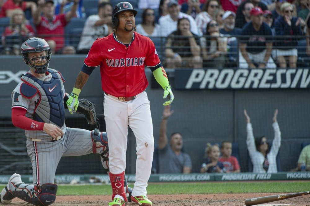 Cleveland Guardians' Jose Ramirez, right, watches his two-run home run off Minnesota Twins starting pitcher Bailey Ober along with Twins' Ryan Jeffers, left, during the fifth inning of a baseball game, Saturday, Aug. 2, 2025, in Cleveland. (AP Photo/Phil Long)