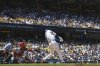 Los Angeles Dodgers' Shohei Ohtani, right, hits a two-run home run and his 1,000th hit as St. Louis Cardinals catcher Pedro Pages watches during the third inning of a baseball game Wednesday, Aug. 6, 2025, in Los Angeles. (AP Photo/Mark J. Terrill)
