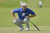 Wyndham Clark of the United States looks at the lie of his putt on the 1st green during the final round of the British Open golf championship at the Royal Portrush Golf Club, Northern Ireland, Sunday, July 20, 2025. (AP Photo/Jon Super)