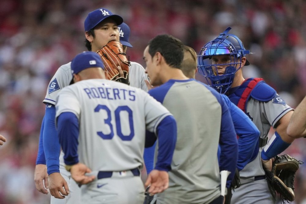Los Angeles Dodgers' Shohei Ohtani is taken out of the game during the fourth inning of a baseball game against the Cincinnati Reds Wednesday, July 30, 2025, in Cincinnati. (AP Photo/Carolyn Kaster)
