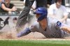 Chicago Cubs' Nico Hoerner scores during the sixth inning of a baseball game against the Chicago White Sox, Sunday, July, 27, 2025, in Chicago. (AP Photo/Matt Marton)