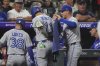 Toronto Blue Jays' Myles Straw, right, puts on a jacket for Bo Bichette as he returns to the dugout after hitting a three-run home run off Colorado Rockies relief pitcher Carson Palmquist in the seventh inning of a baseball game Monday, Aug. 4, 2025, in Denver. (AP Photo/David Zalubowski)
