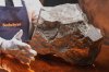 A Martian meteorite, weighing 54.388 lbs. (24.67 kg), said to be the largest piece of Mars on Earth, is displayed at Sotheby's, in New York, Wednesday, July 9, 2025, part of their Geek Week auction, July 16, 2025. (AP Photo/Richard Drew)