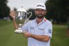 Cameron Young poses with the trophy after winning the Wyndham Championship golf tournament in Greensboro, N.C., Sunday, Aug. 3, 2025. (AP Photo/Chuck Burton)