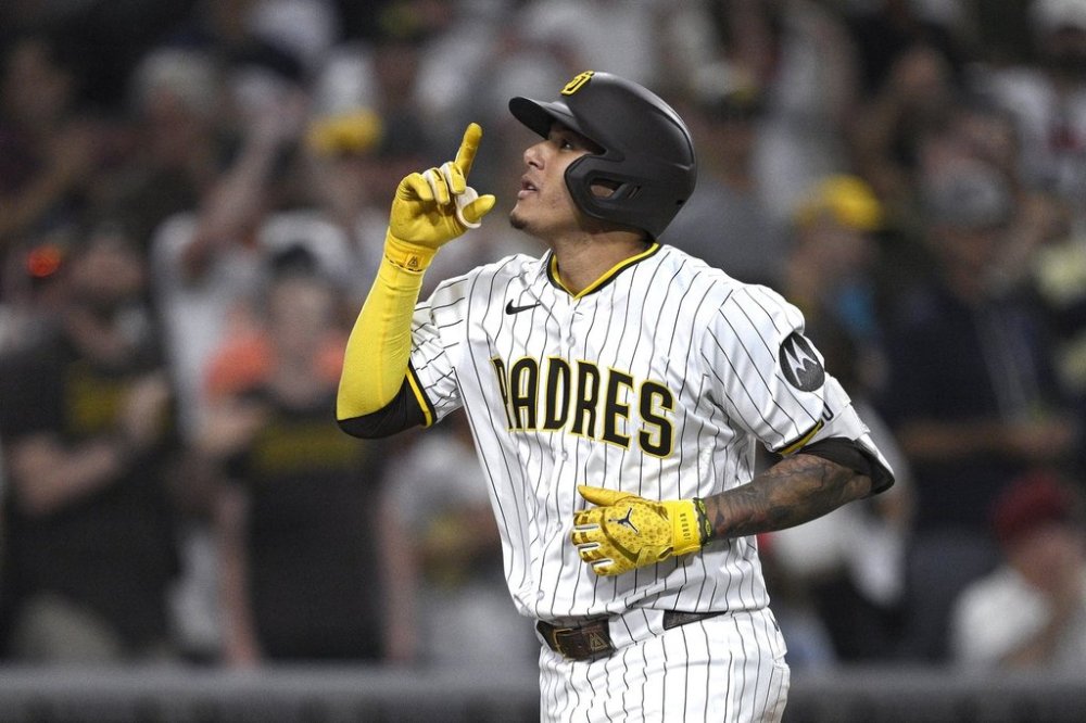 San Diego Padres' Manny Machado celebrates after hitting a home run during the fifth inning of a baseball game against the Arizona Diamondbacks, Thursday, July 10, 2025, in San Diego. (AP Photo/Orlando Ramirez)