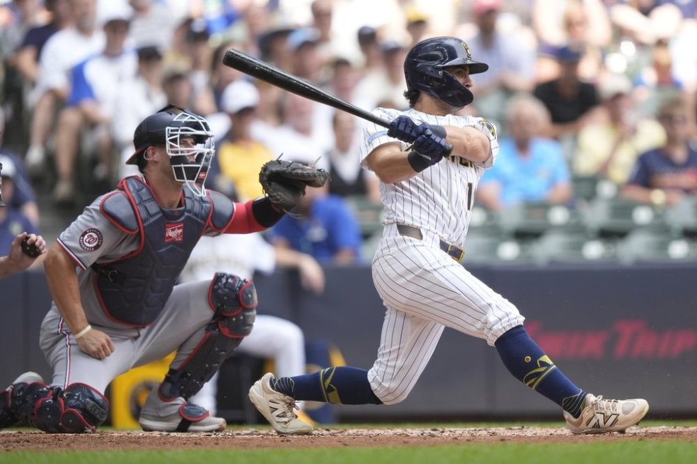 Milwaukee Brewers' Sal Frelick hits an RBI single during the second inning of a baseball game against the Washington Nationals, Sunday, July 13, 2025, in Milwaukee. (AP Photo/Aaron Gash)
