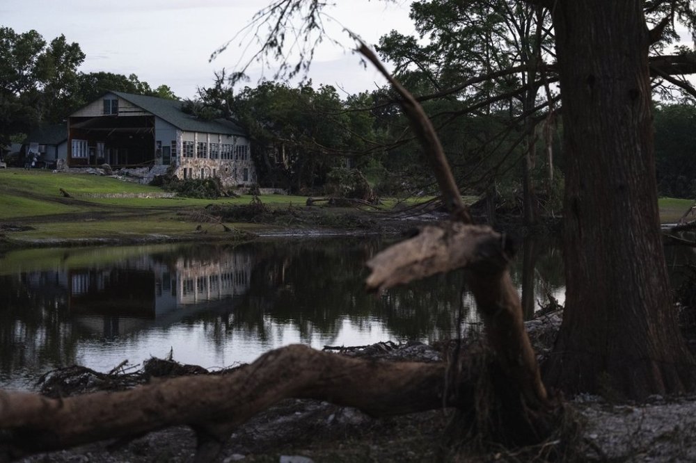 FILE - Camp Mystic is reflected in water after a flash flood swept through the area July 7, 2025, in Hunt, Texas. (AP Photo/Eli Hartman, File)