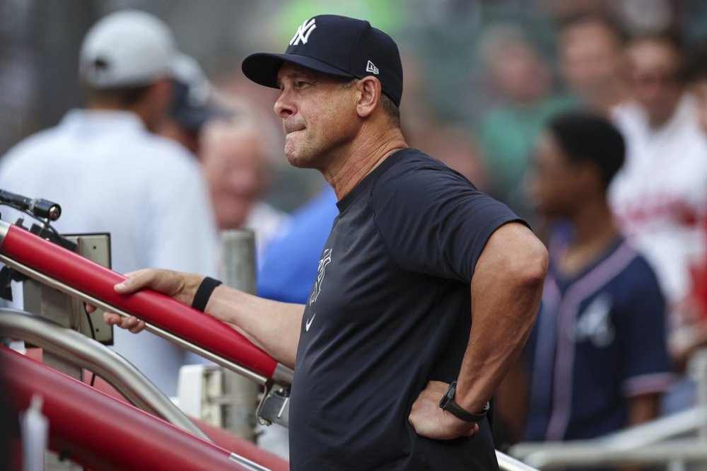 New York Yankees manager Aaron Boone reacts during the third inning of a baseball game against the Atlanta Braves, Friday, July 18, 2025, in Atlanta. (AP Photo/Colin Hubbard)