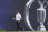 Brian Harman of the United States acknowledges the crowd after making a birdie putt on the 18th green during the second round of the British Open golf championship at the Royal Portrush Golf Club, Northern Ireland, Friday, July 18, 2025. (AP Photo/Jon Super)