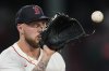 Boston Red Sox starting pitcher Garrett Crochet covers first base on a throw by first baseman Abraham Toro to make the out on Kansas City Royals Vinnie Pasquantino in the sixth inning, Tuesday, Aug. 5, 2025, in Boston. (AP Photo/Robert F. Bukaty)