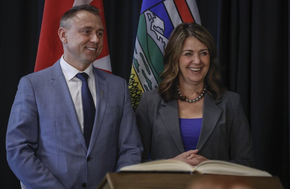 Alberta Premier Danielle Smith, right, stands with new Minister of Tourism and Sport, Andrew Boitchenko, following a swearing in ceremony in Calgary, Alta., Friday, May 16, 2025.THE CANADIAN PRESS/Jeff McIntosh