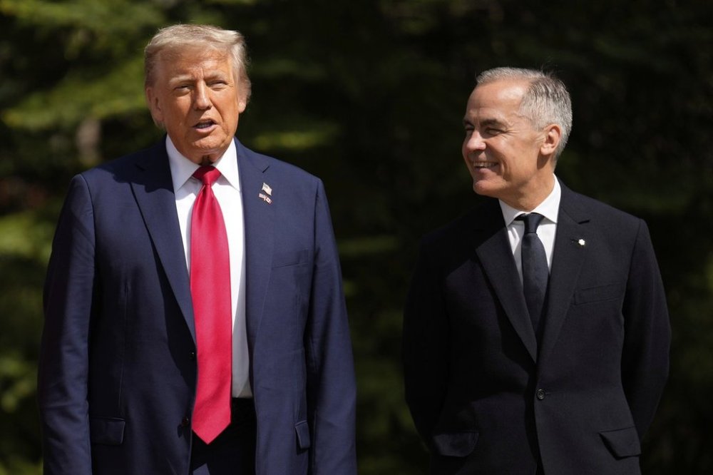 Business leaders and academics say they hope to see Canada and the U.S. maintain free trade protections for most goods once an agreement is reached, even if the negotiations can't stave off certain sectoral tariffs. Canada's Prime Minister Mark Carney, right, greets President Donald Trump during the official welcome of the G7 Summit, Monday, June 16, 2025, in Kananaskis, Canada. (AP Photo/Mark Schiefelbein)