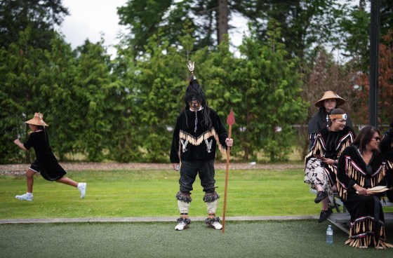 Musqueam Nation member Wes Grant, centre, wears ceremonial dress in Vancouver as a memorandum of understanding is announced regarding hosting FIFA World Cup 26 matches, in Vancouver on June 27. The MOU between the provincial government, city and the Musqueam, Squamish and Tsleil-Waututh Nations sets out a framework on how they will all work together to plan, stage and host matches, while ensuring interests of the nations are reflected. (Darryl Dyck / The Canadian Press files)
