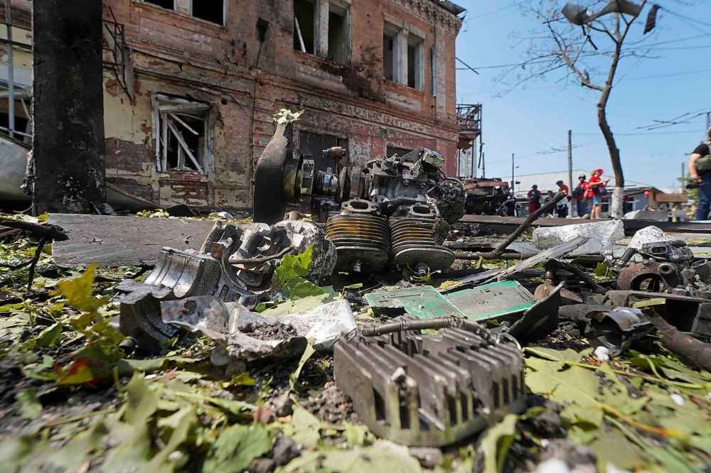 Fragments of the Russian drone and debris lie on the ground after a Russian airstrike in Kharkiv, Ukraine, Monday, July 7, 2025. (AP Photo/Andrii Marienko)