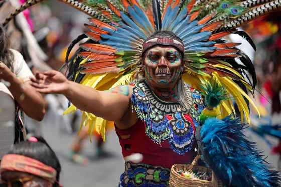 A dancer in Indigenous clothing performs during a celebration to mark the 700th anniversary of the founding of Tenochtitlan, known today as Mexico City, in the capital's main square on July 26. (Eduardo Verdugo / The Associated Press files)