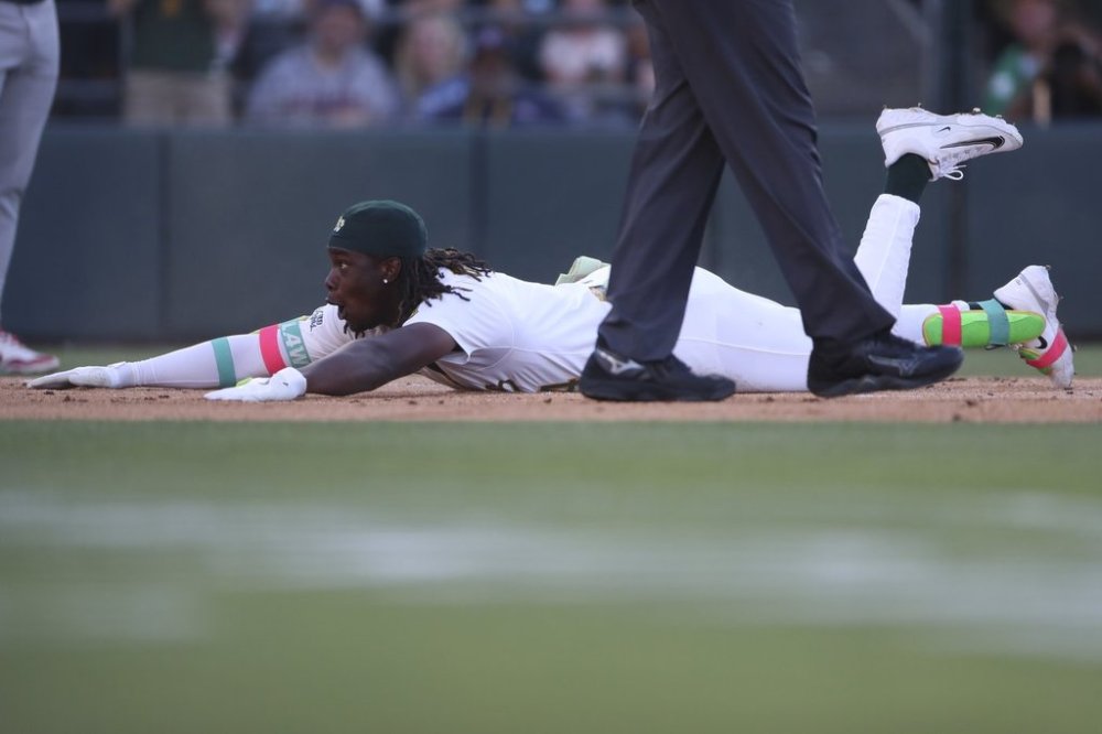 Athletics' Lawrence Butler slides into home plate as he hits an inside-the-park home run against the Atlanta Braves during the first inning of a baseball game Tuesday, July 8, 2025, in West Sacramento, Calif. (AP Photo/Scott Marshall)