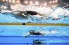 Regan Smith of the United States, top, Kylie Masse of Canada and Taylor Ruck of Canada compete in the women's 100m backstroke final at the World Aquatics Championships in Singapore, Tuesday, July 29, 2025. (AP Photo/Lee Jin-man)