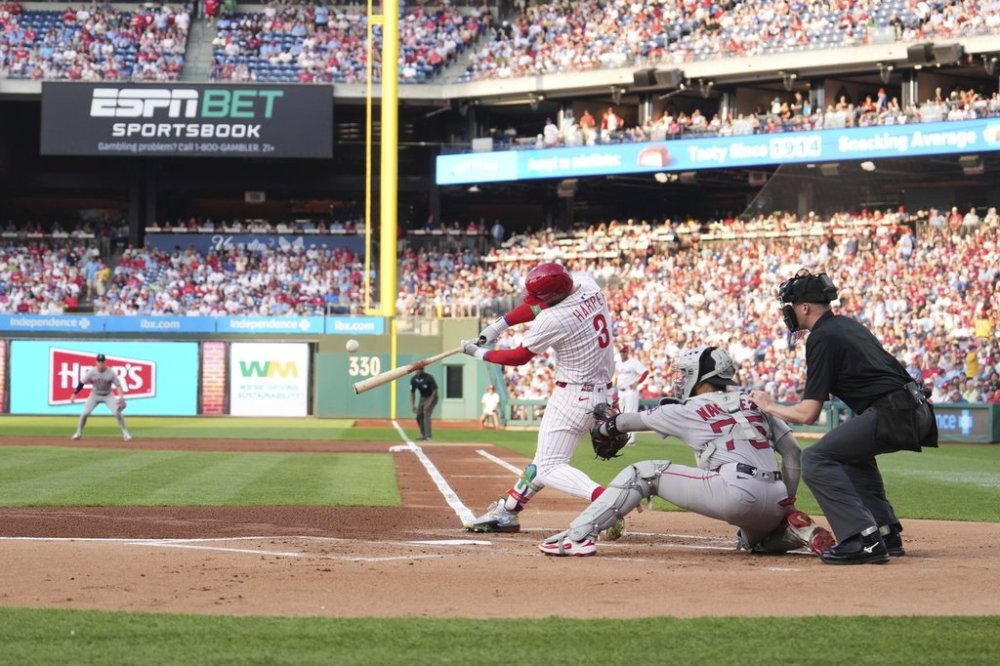 Philadelphia Phillies' Bryce Harper hits a home run against Boston Red Sox pitcher Lucas Giolito during the first inning of a baseball game Wednesday, July 23, 2025, in Philadelphia. (AP Photo/Matt Slocum)