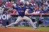 Texas Rangers starting pitcher Nathan Eovaldi throws to the plate during the first inning of a baseball game against the Los Angeles Angels Wednesday, July 30, 2025, in Anaheim, Calif. (AP Photo/Mark J. Terrill)