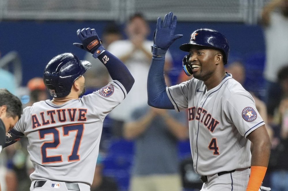 Houston Astros' Jose Altuve celebrates after hitting a two-run homer that brought home Jesus Sanchez (4), in the first inning of a baseball game against the Miami Marlins, Tuesday, Aug. 5, 2025, in Miami. (AP Photo/Rebecca Blackwell)