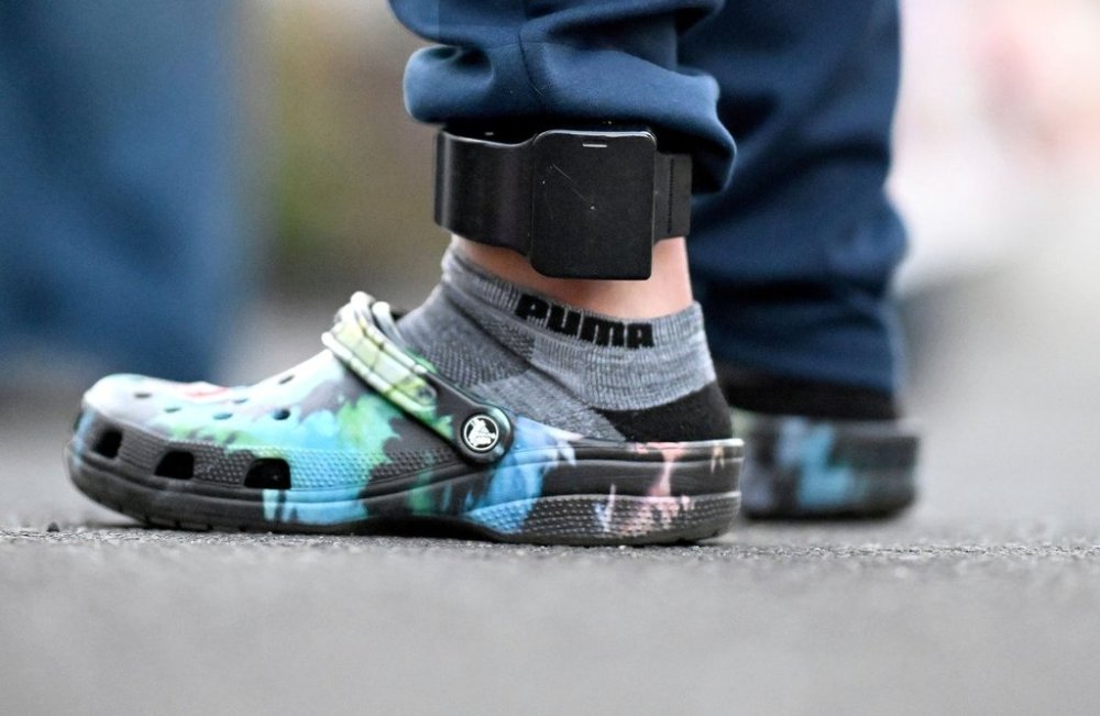 Jose Zavala, an undocumented gardener who was detained by Immigration and Customs Enforcement on June 18, while on a job in La Mirada, and was released from a processing facility in El Paso, Texas, after his wife paid a $5,000 bond, stands in an ankle monitor outside his home in Pomona, Calif., Wednesday, July 30, 2025. (Will Lester/The Orange County Register via AP)