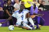 CF Montreal forward Prince Osei Owusu, left, and Orlando City midfielder Cesar Araujo get tangled up going for the ball during the second half of an MLS soccer match, Saturday, July 12, 2025, in Orlando, Fla. (AP Photo/John Raoux)