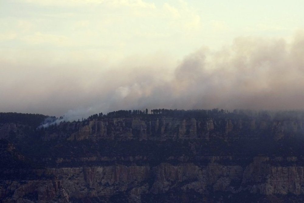 Smoke from the Dragon Bravo Fire moves across the Grand Canyon from the North Rim Tuesday, July 15, 2025, in Grand Canyon National Park, Ariz. (AP Photo/Ross D. Franklin)