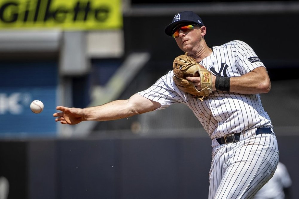 New York Yankees second base DJ LeMahieu (26) grounds out Athletics' Max Muncy (10) during the sixth inning of a baseball game, Saturday, June 28, 2025, in New York. (AP Photo/Angelina Katsanis)
